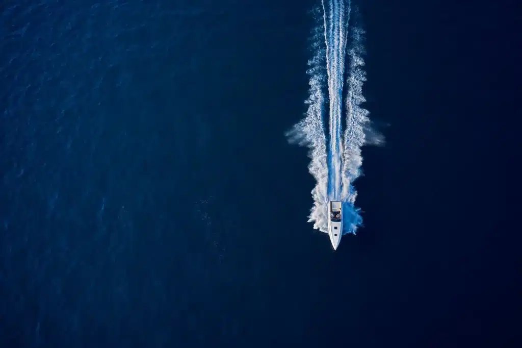 Large speed boat moving at high speed on Lake Norman from the top, aerial view boat sailing. Motor boat in the sea.