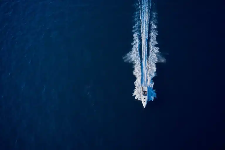 Large speed boat moving at high speed on Lake Norman from the top, aerial view boat sailing. Motor boat in the sea.