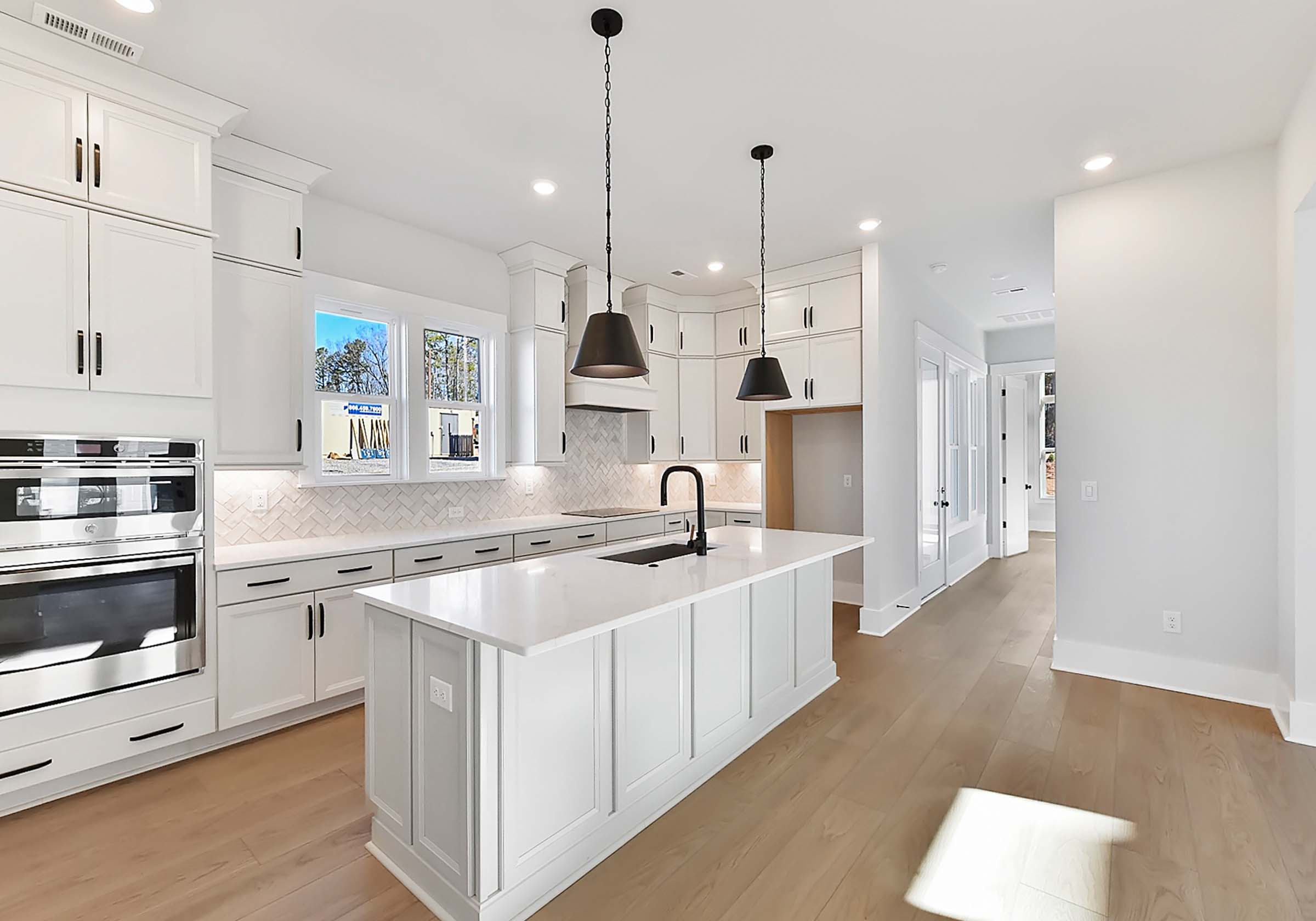  - View 2, Opens Model BoxAn interior shot of the kitchen of 4314 Morning Mist Drive, focused on the island and the hallway.