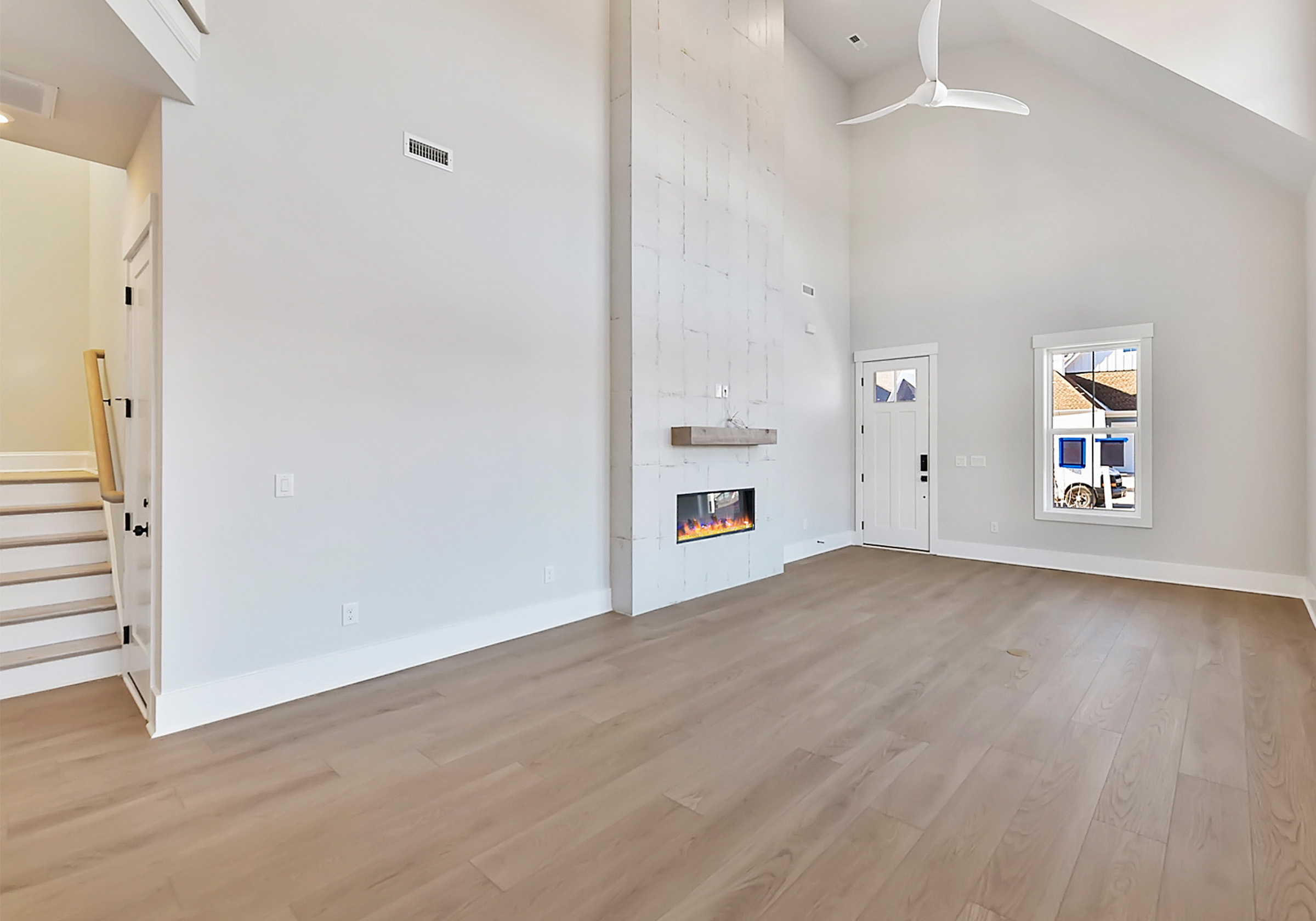  - View 10, Opens Model BoxAn interior shot of the staircase and living room of 4314 Morning Mist Drive.