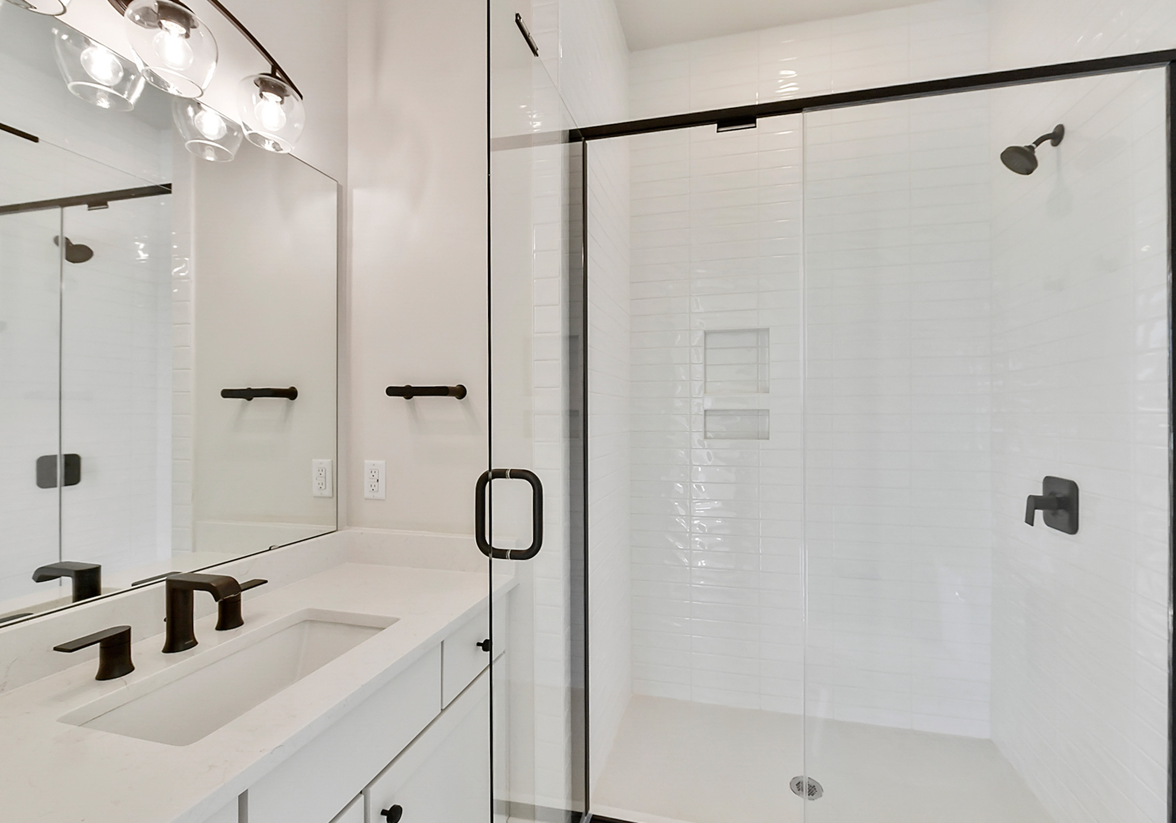 - View 1, Opens Model BoxAn interior shot of the primary bathroom of 4379 Morning Mist Drive, focused on the shower and sink.